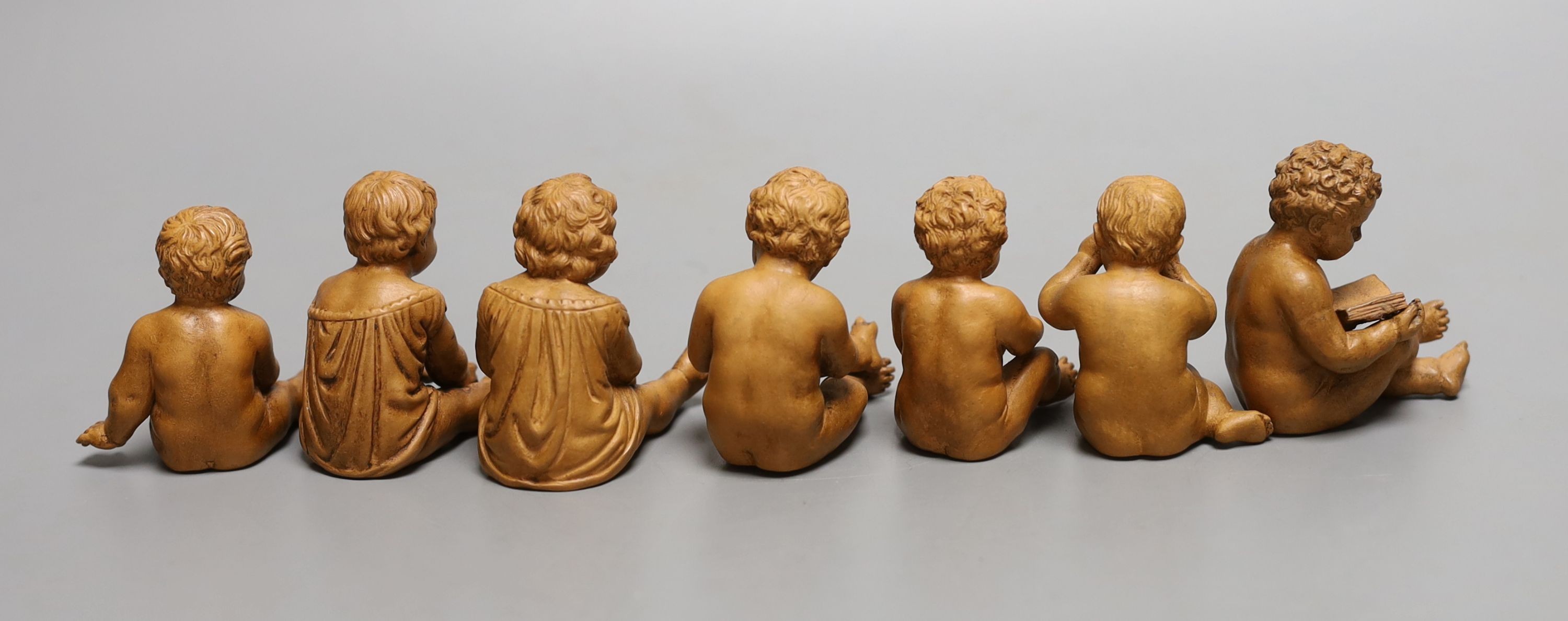 A group of seven terracotta figures of playful youths